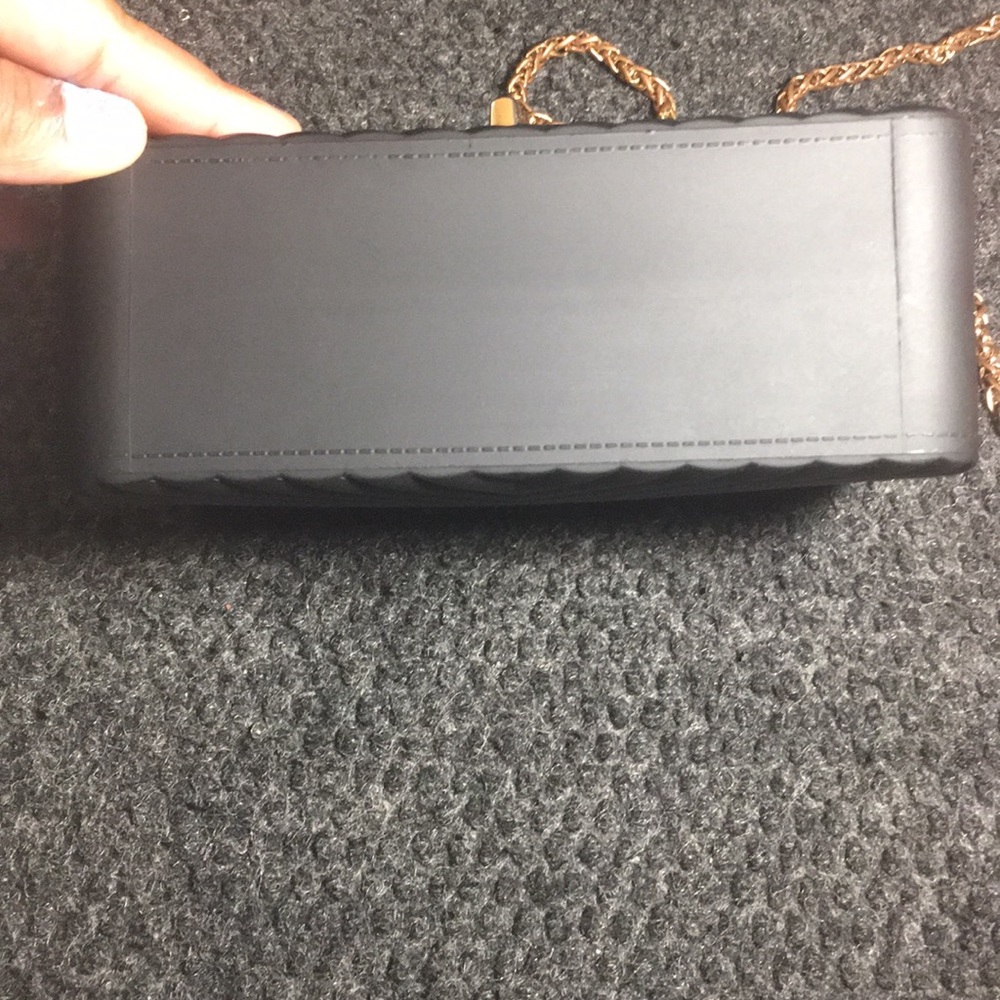 Black purse with rose gold buckle